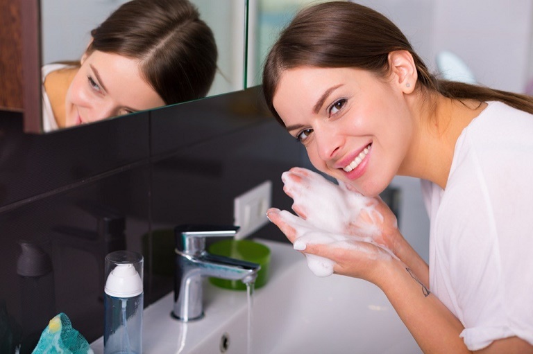 washing face with natural cleanser