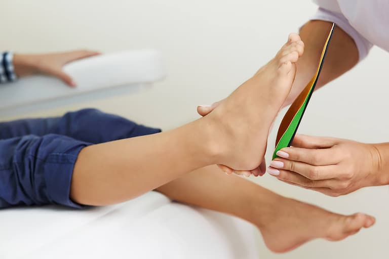 podiatrist checking patients foot