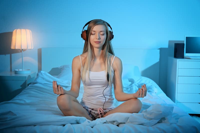 woman meditating before sleep