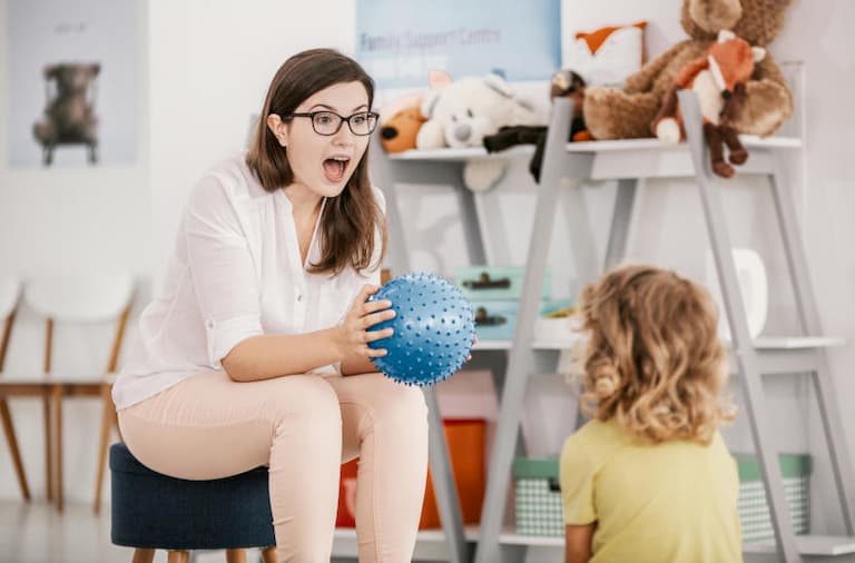 teacher playing with children with special needs