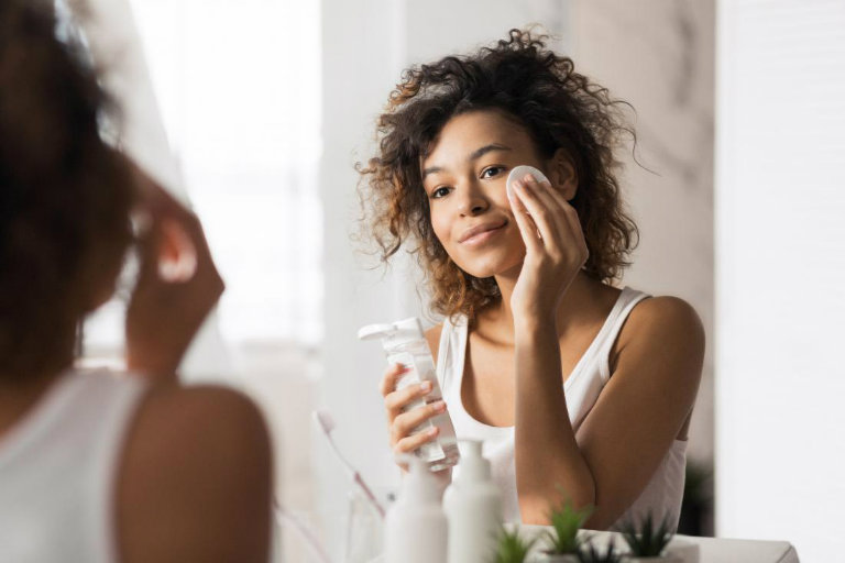 young-woman-using-face-cleanser-for-black-skin-care