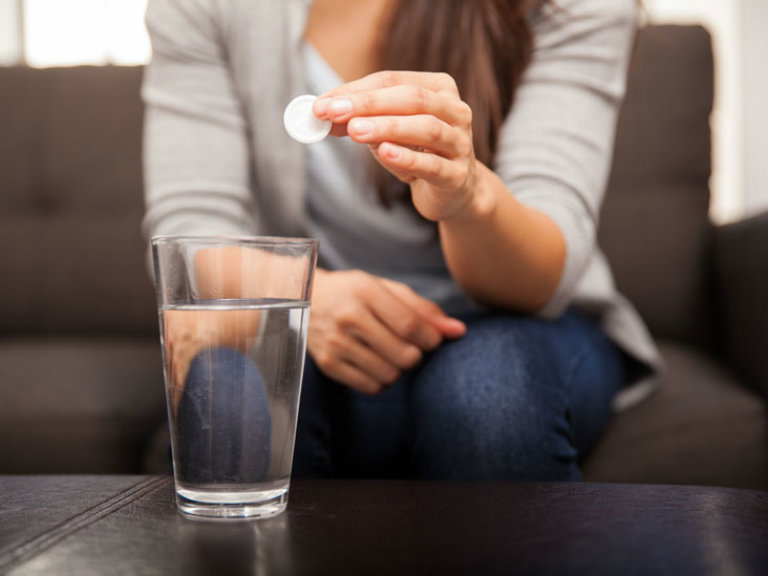 girl drinling antacid