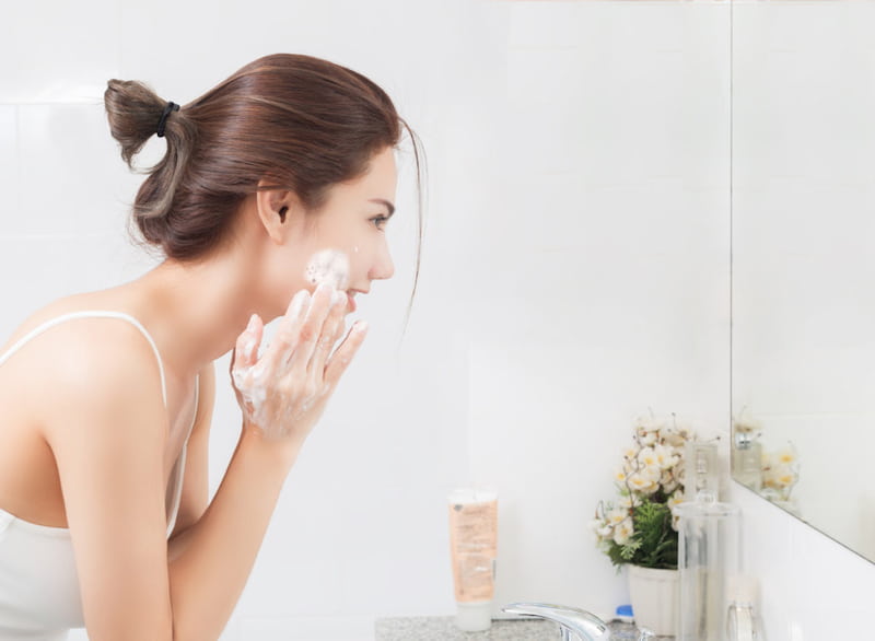 woman washing her face