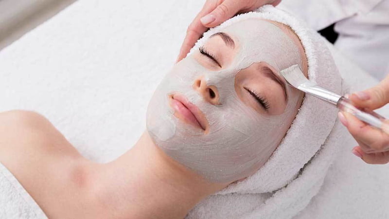 woman with clay mask on her face