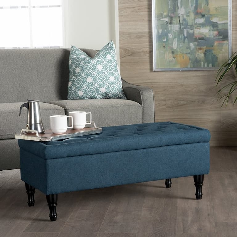 blue ottoman from living room as a coffee table in fornt of the gray sofa bed