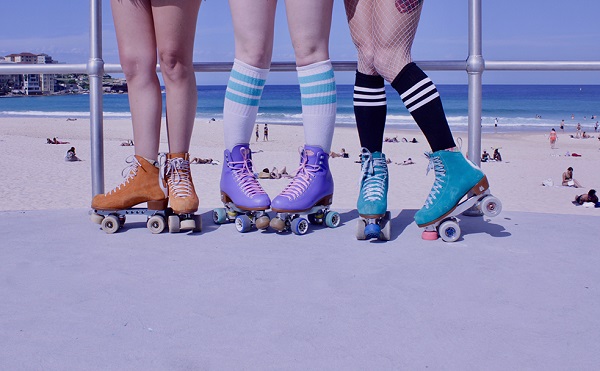 picture of girls in different roller skates near the beach