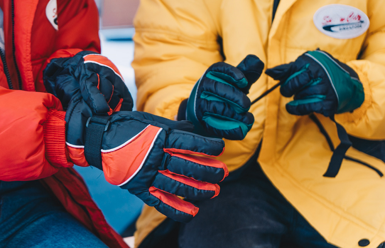 Putting on snow gloves