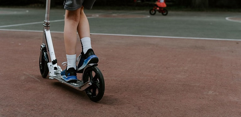 boy on scooter at playground