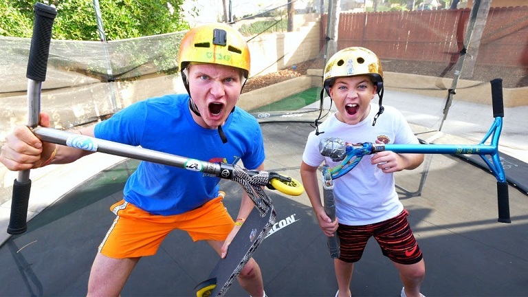 boys having fun with trampoline scooters