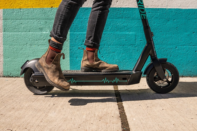 fancy scooter photo with person wearing boots and socks