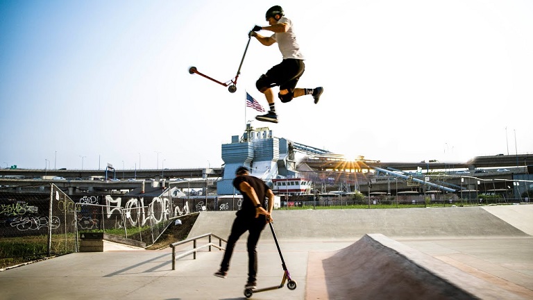 two people doing tricks with pro scooters