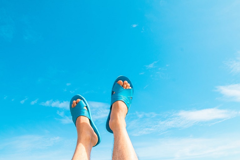 picture of persons feet in blue slides up to the sky 