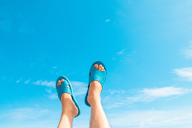 picture of persons feet in blue slides up to the sky