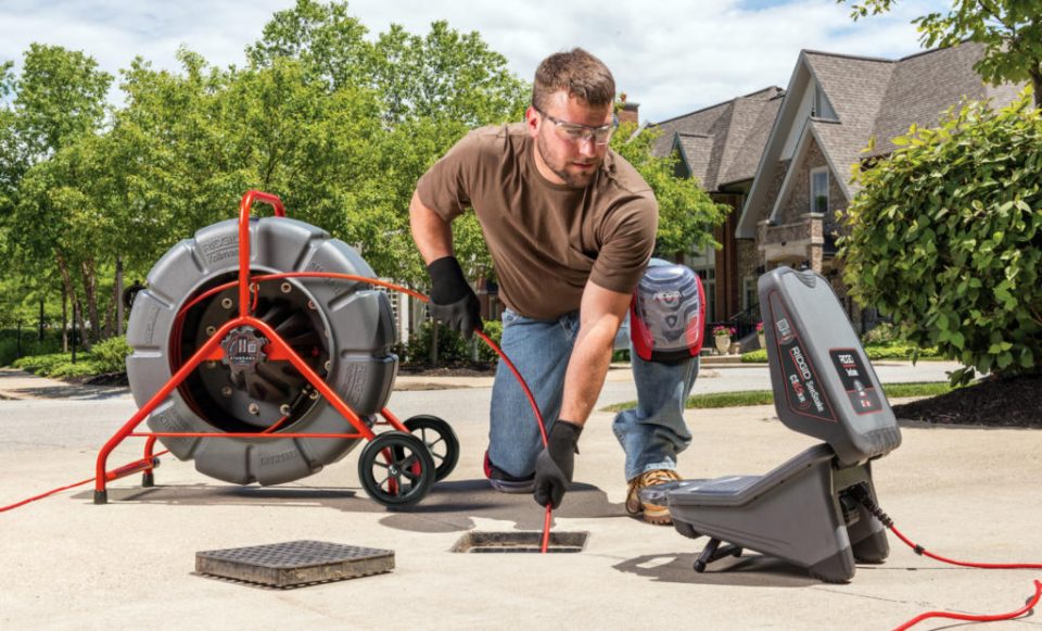 Man working with pipe inspection camera