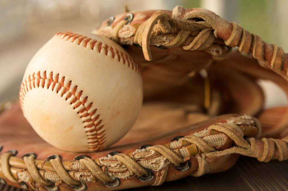 Ball in baseball glove with older material