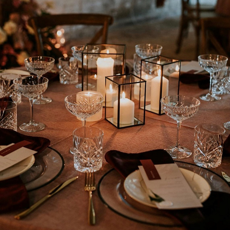 wedding table decorated with white pillar candles