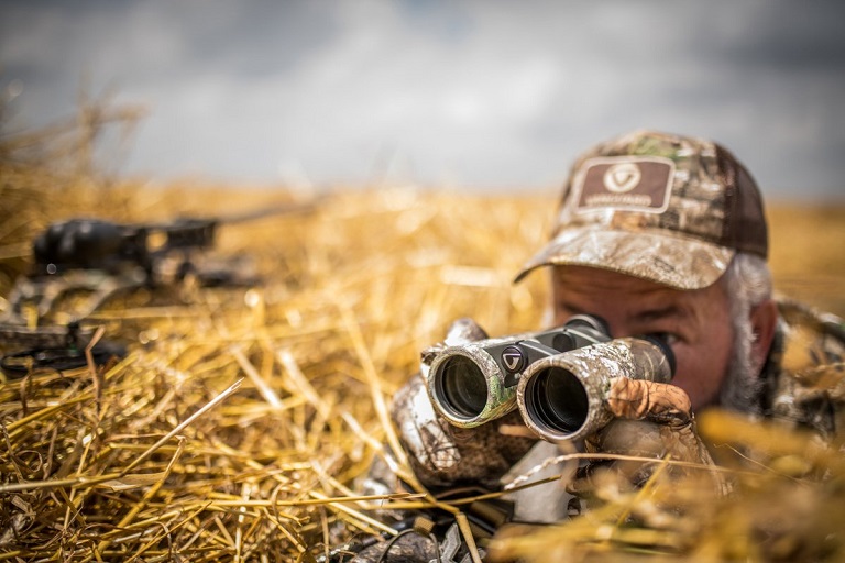 Close-up of a hunter using binoculars