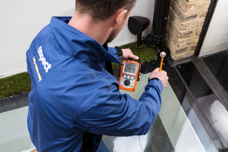 Man working with water leak detector