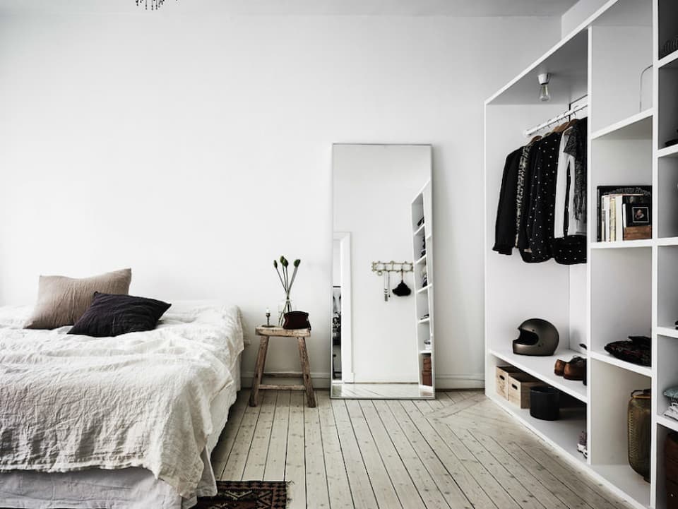 Scandinavian bedroom with mirror and white details