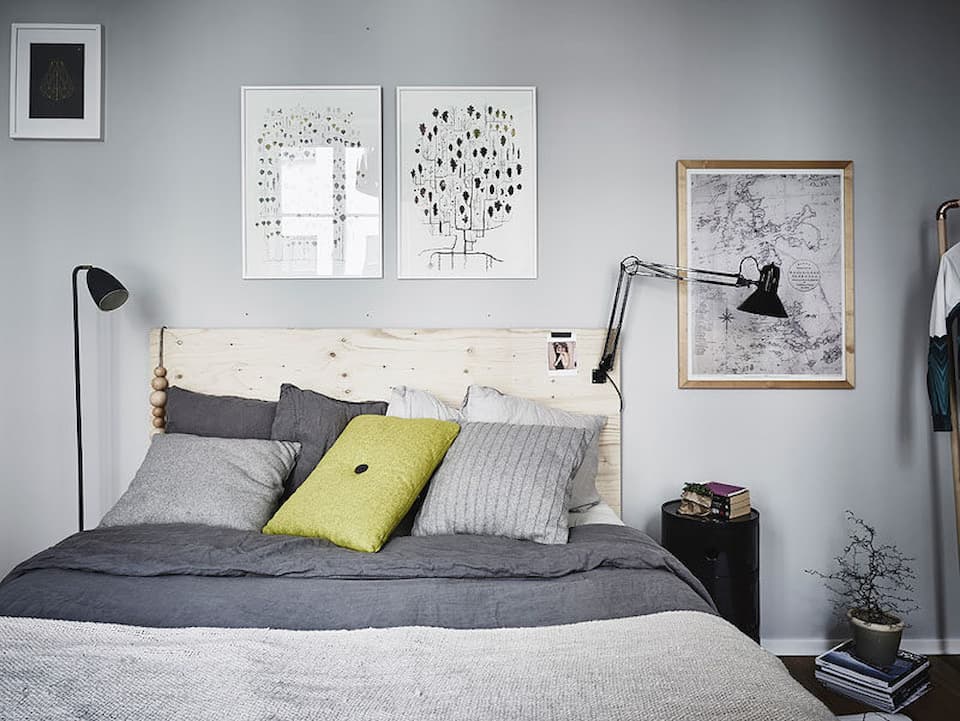 Scandinavian Bedroom with soft grey and yellow blankets and pillows 