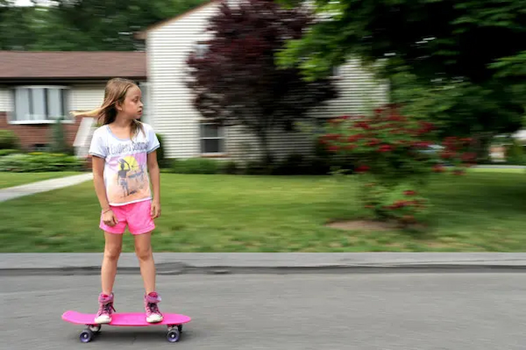 girl riding a penny board