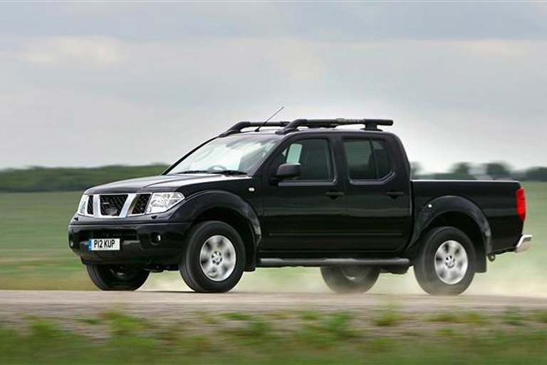 Black Nissan Navara driven in nature