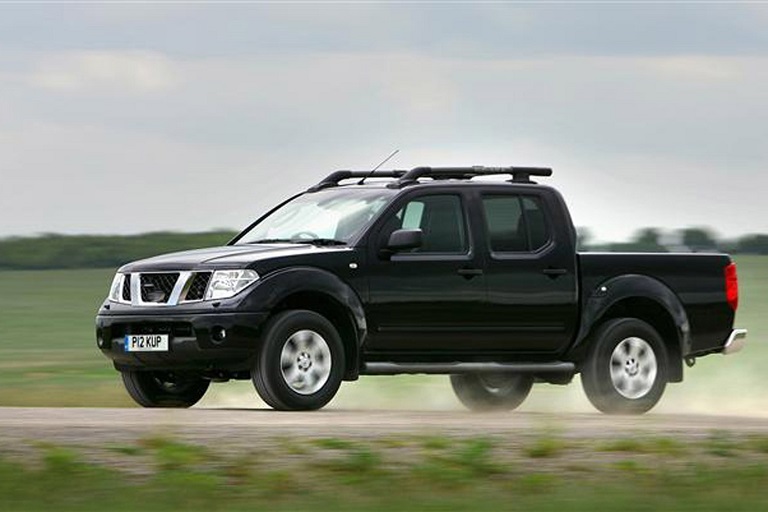 Black Nissan Navara  driven in nature