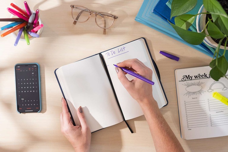 person ready to fill a to-do list in his/her diary