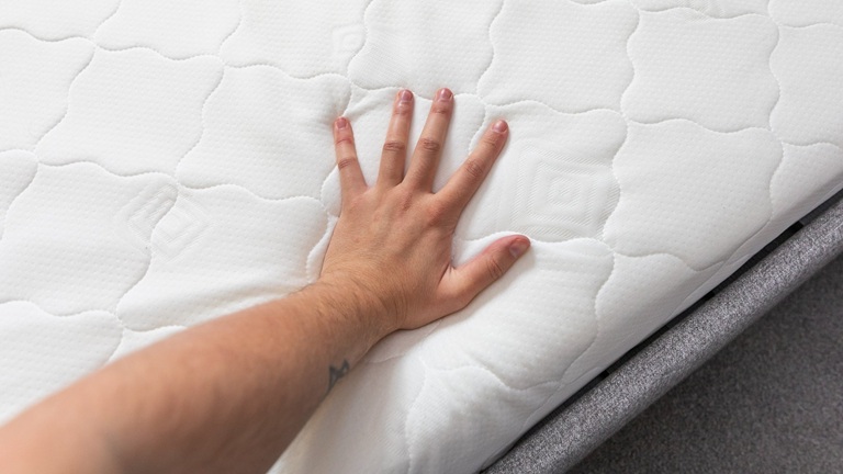 hand on a quality mattress