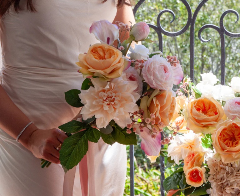 bride holding artificial wedding bouquet